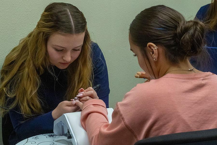 A 火博体育 student giving a manicure